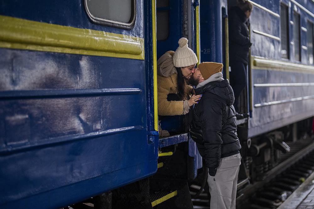 Stanislav, 40, kisses his wife Anna, 35, on a train to Lviv as they say goodbye at the Kyiv station, Ukraine, on Thursday