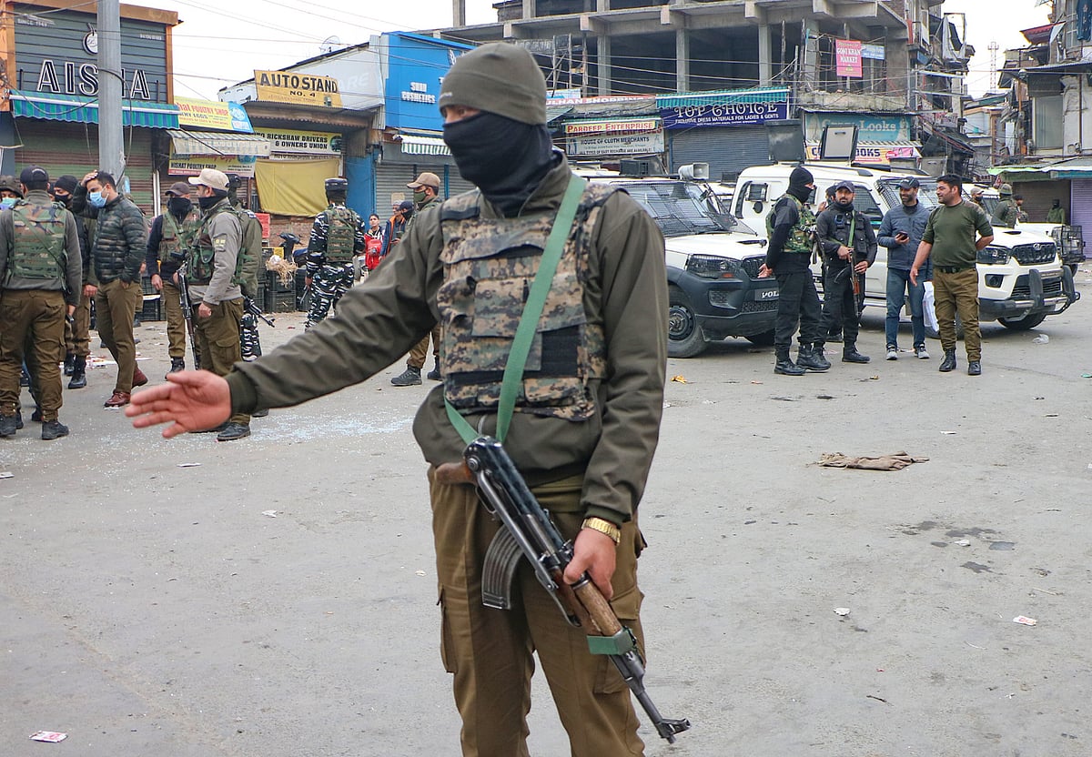 Police cops remain alert around the spot where suspected militants lobbed a grenade towards security forces in Amira Kadal area of  Srinagar 
