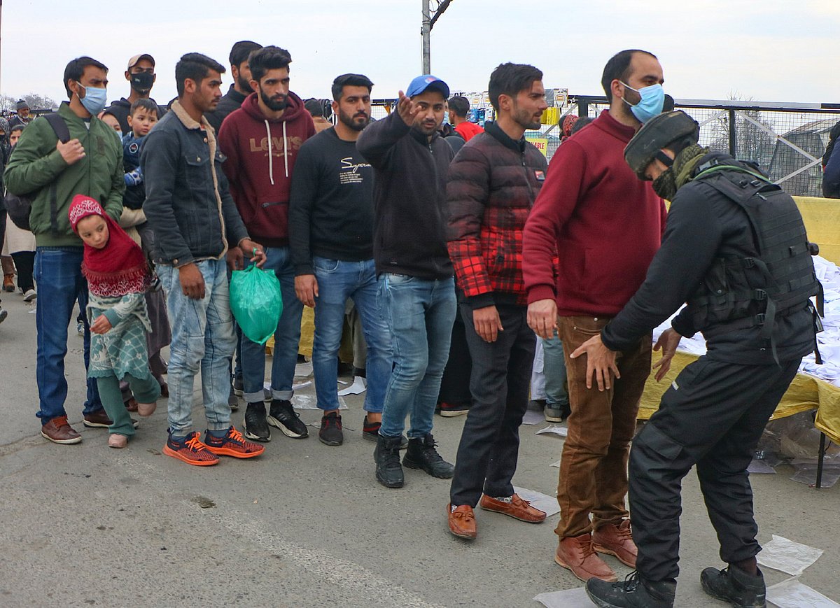 Civilians are lined up for frisking near the spot where suspected militants lobbed a grenade towards security forces in Amira Kadal area of Srinagar 