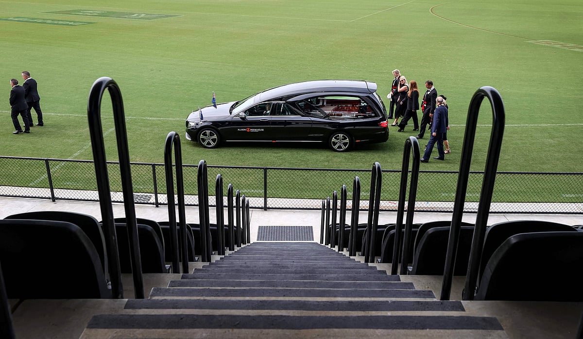 The family of Australian cricket superstar Shane Warne follows the hearse on a lap of the ground after a private memorial service at the St Kilda Football Club in Melbourne