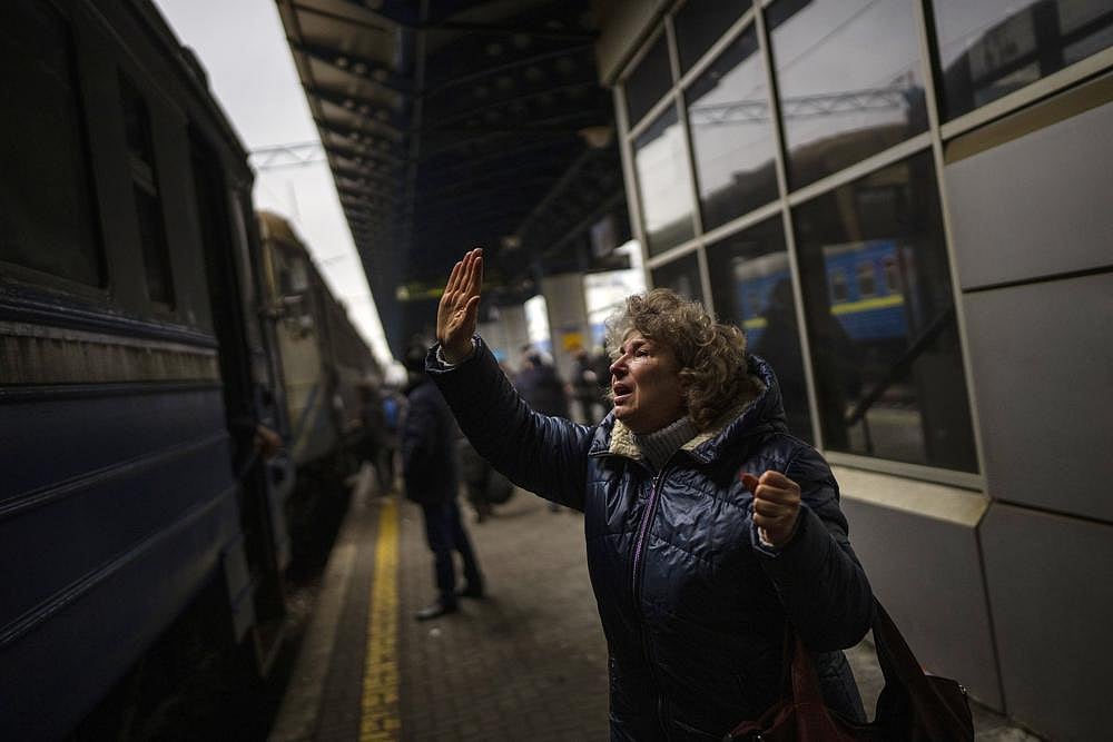 Natalia, 57, says goodbye to her daughter and grandson on a train to Lviv at the Kyiv station, Ukraine, on Thursday