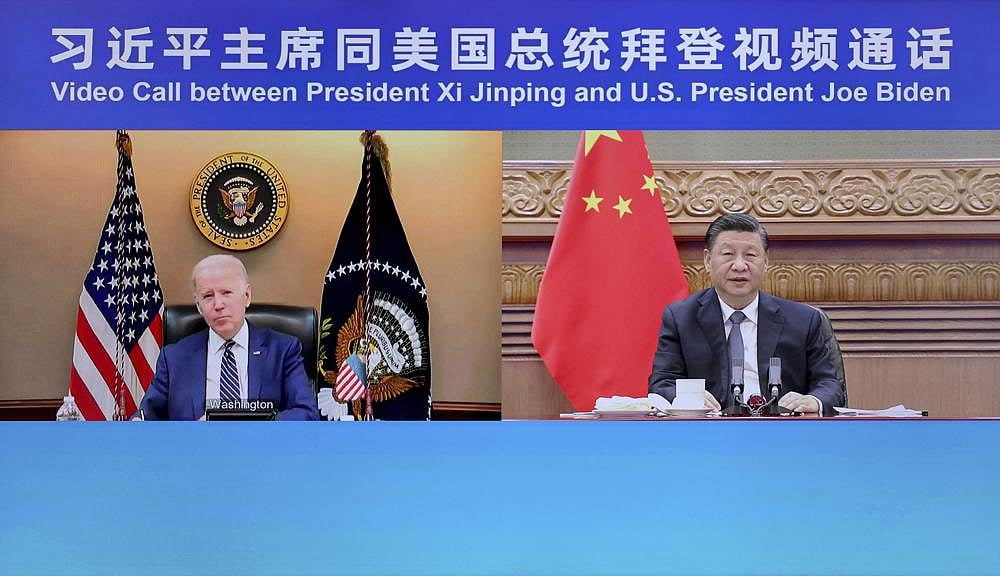 In this photo released by Xinhua News Agency, a screen showing Chinese President Xi Jinping, right, meets with U.S. President Joe Biden via a video call on Friday, March 18, 2022, in Beijing, China | Xinhua via AP
