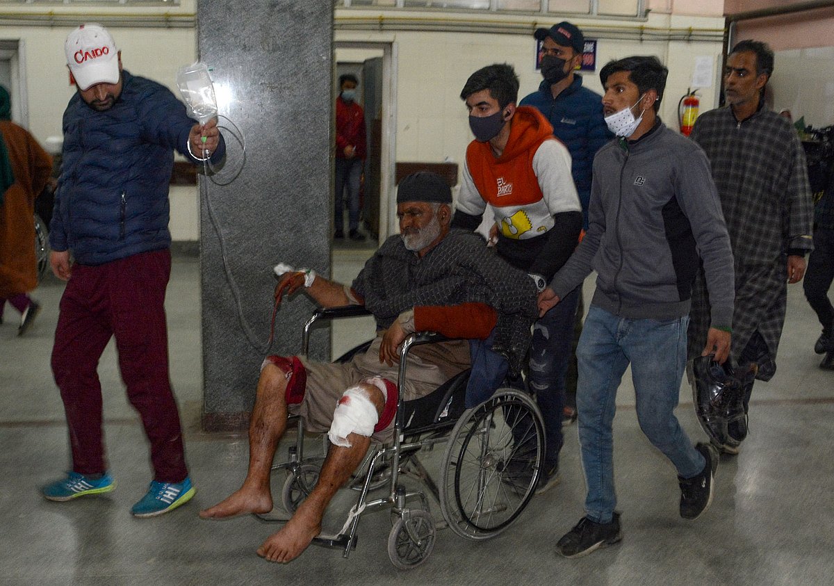 An injured man being carried on a stretcher at the hospital after a grenade explosion in Srinagar, Kashmir on Sunday