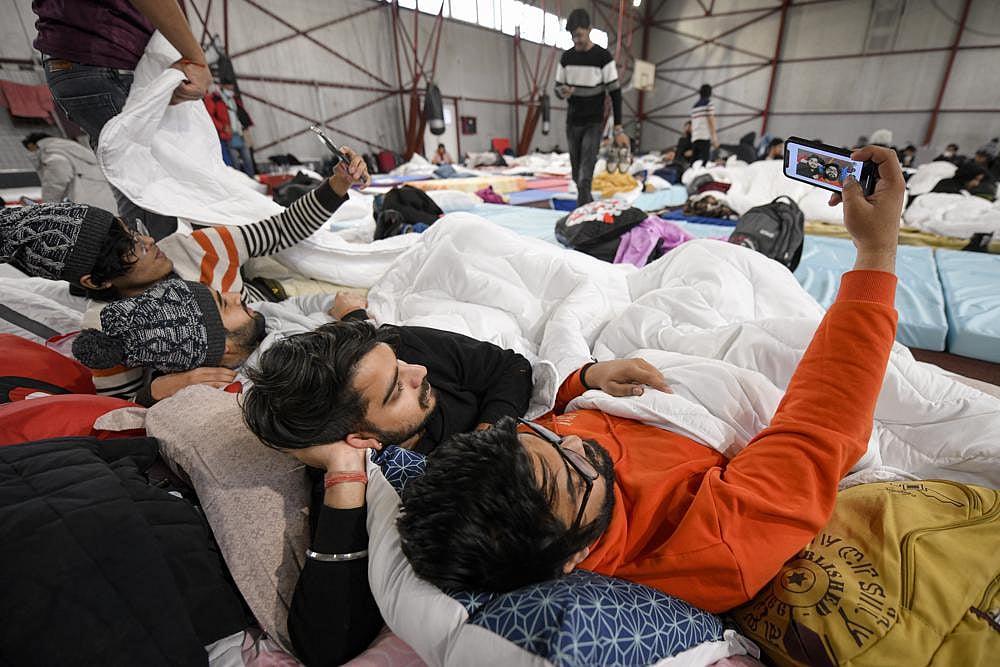 Students from India studying in Ukraine that fled the conflict from neighbouring Ukraine take a selfie at a refugee camp in Voluntari, Romania | AP