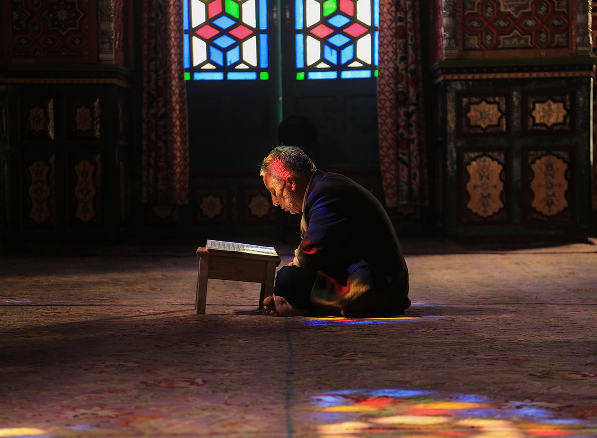 Kashmiri Muslims recite the Holy Koran inside the shrine during the holy month of Ramadan in Srinagar, Kashmir. 