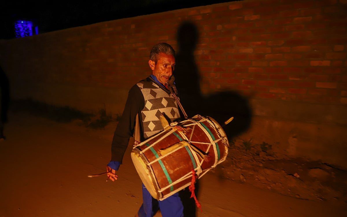 Ali Mohammad 55, a Kashmiri Ramadan drummer or human alarm locally known as Sahar Khanâ bangs his drum as he walks through the dark alleys in the outskirts of Srinagar, Kashmir