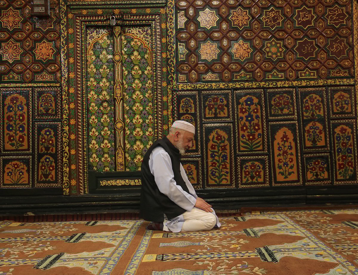 A Kashmiri man pray inside the shrine during the holy month of Ramadan in Srinagar, Kashmir
