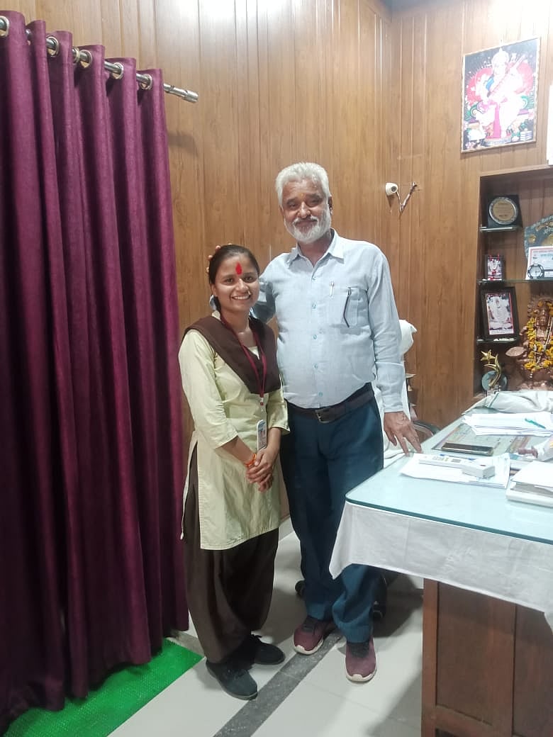 Class 10 topper Nancy Dubey taking blessings from her school principal  | 