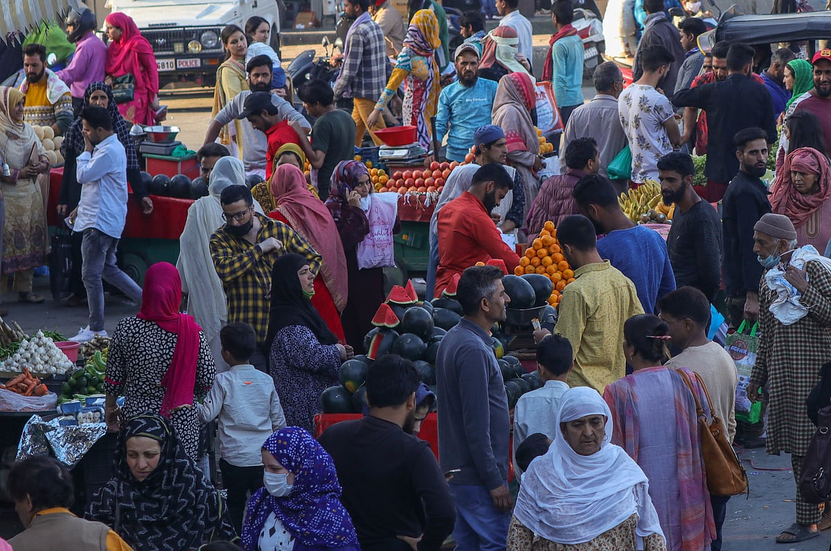 Kashmiri people buy vegetables and other essential items at a market during the holy month of Ramadan in Srinagar, Kashmir. 
