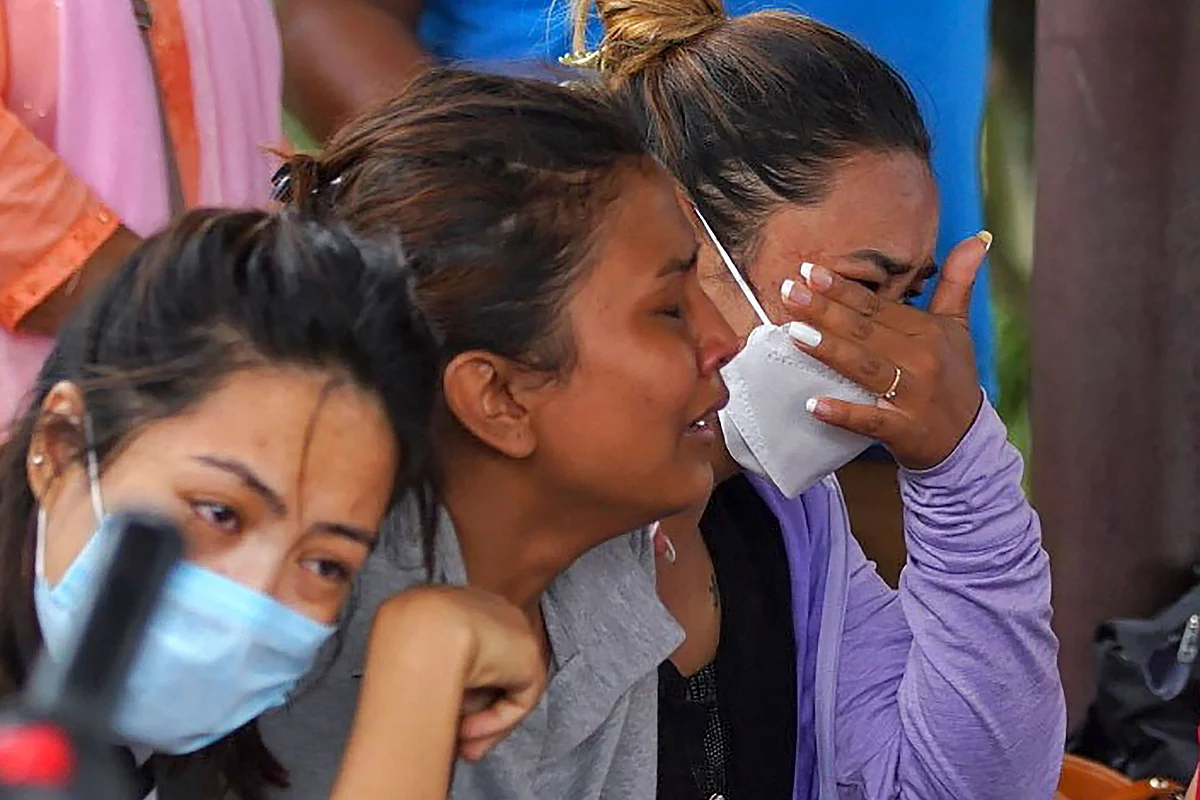 Family members and relatives of passengers on board the Twin Otter aircraft operated by Tara Air, weep outside the airport in Pokhara on May 29, 2022