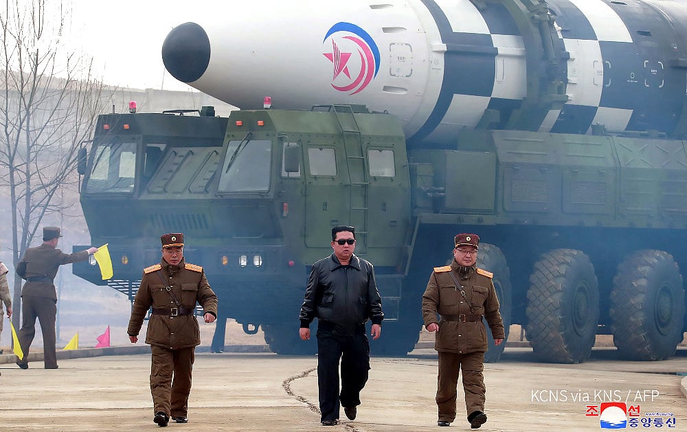 Kim-jong Un walking away from a nuclear-capable intercontinental ballistic missile | KCNA via AFP