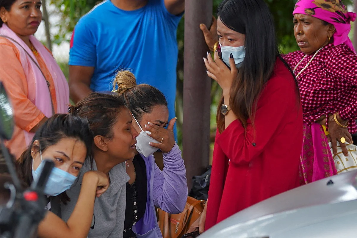 Family members and relatives of passengers on board the Twin Otter aircraft operated by Tara Air, weep outside the airport in Pokhara on May 29, 2022