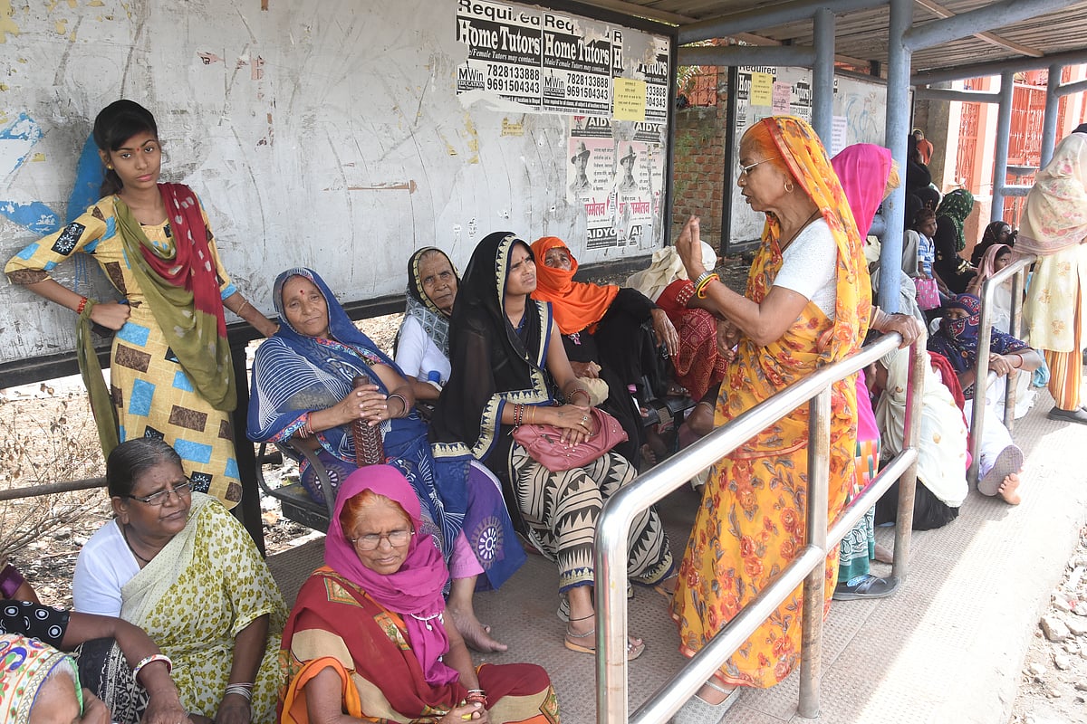 Gas victims stand at bus stop after they were prevented from meeting union health minister during his visit to BMHRC on Sunday