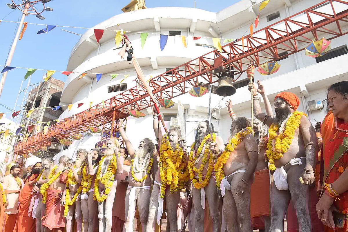 Sadhus and sanyasis wave traditional arms before marching for the Peshwai