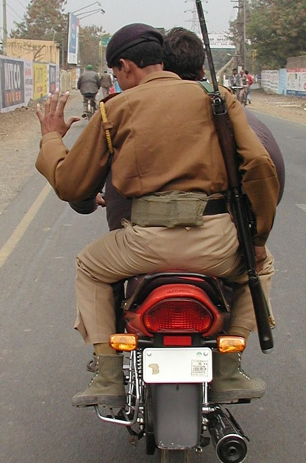 While common people are being fined for having incorrect number plates, two cops are riding a motorcycle without number plate.