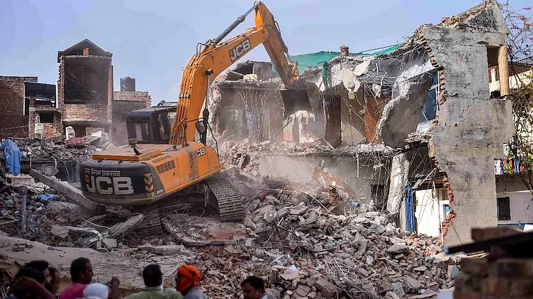 Bulldozer being used to demolish the 'illegally constructed' residence of Javed Mohammad in Prayagraj, on June 12 | PTI