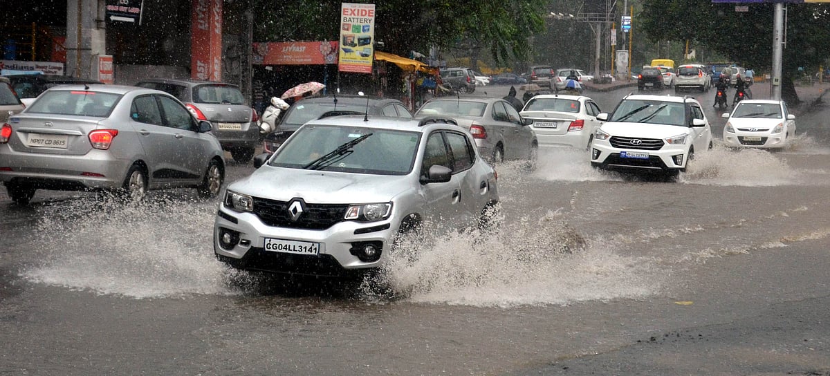 Motorists wading through water-logged roads 