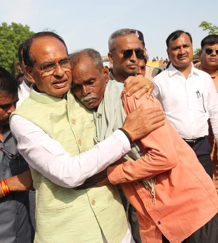 Chief Minister Shivraj Singh Chouhan consoles a flood-affected in Vidisha district on Wednesday
