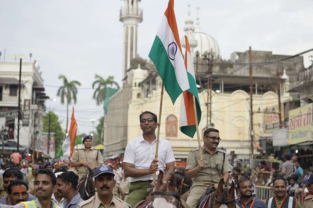 Collector Asheesh Singh and SP Satyendra Kumar Shukla ride on police horse to propagate the message of “Har Ghar Tiranga Abhiyan” during the fourth procession of Lord Mahakal in Ujjain on Monday.