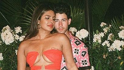 Priyanka Chopra oozes oomph in strapless red dress and husband Nick Jonas can't keep his hands off...