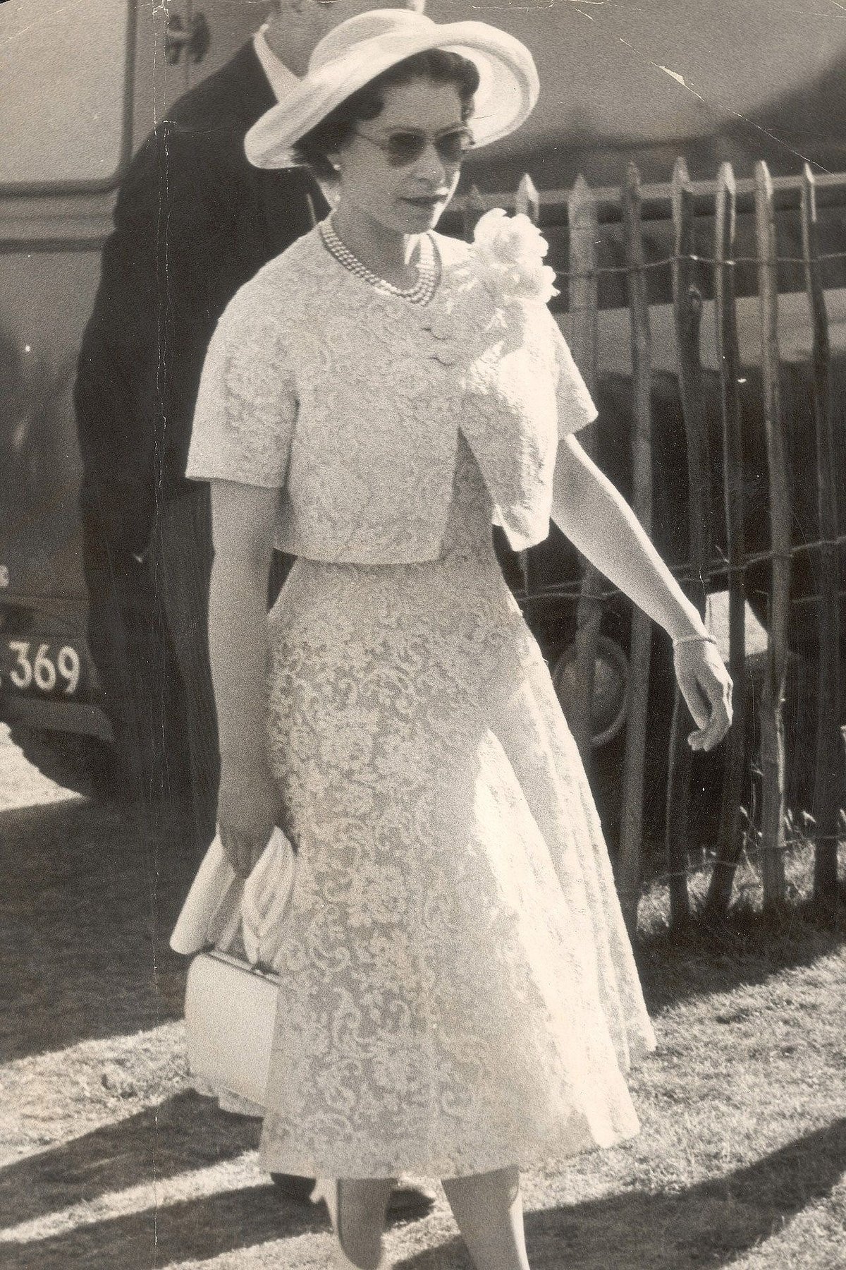 1959: The Queen looked stunning in a lace dress paired with a matching jacket, a flower brooch and her favourite three-layered plum choker for a cocktail party at Windsor Castle.