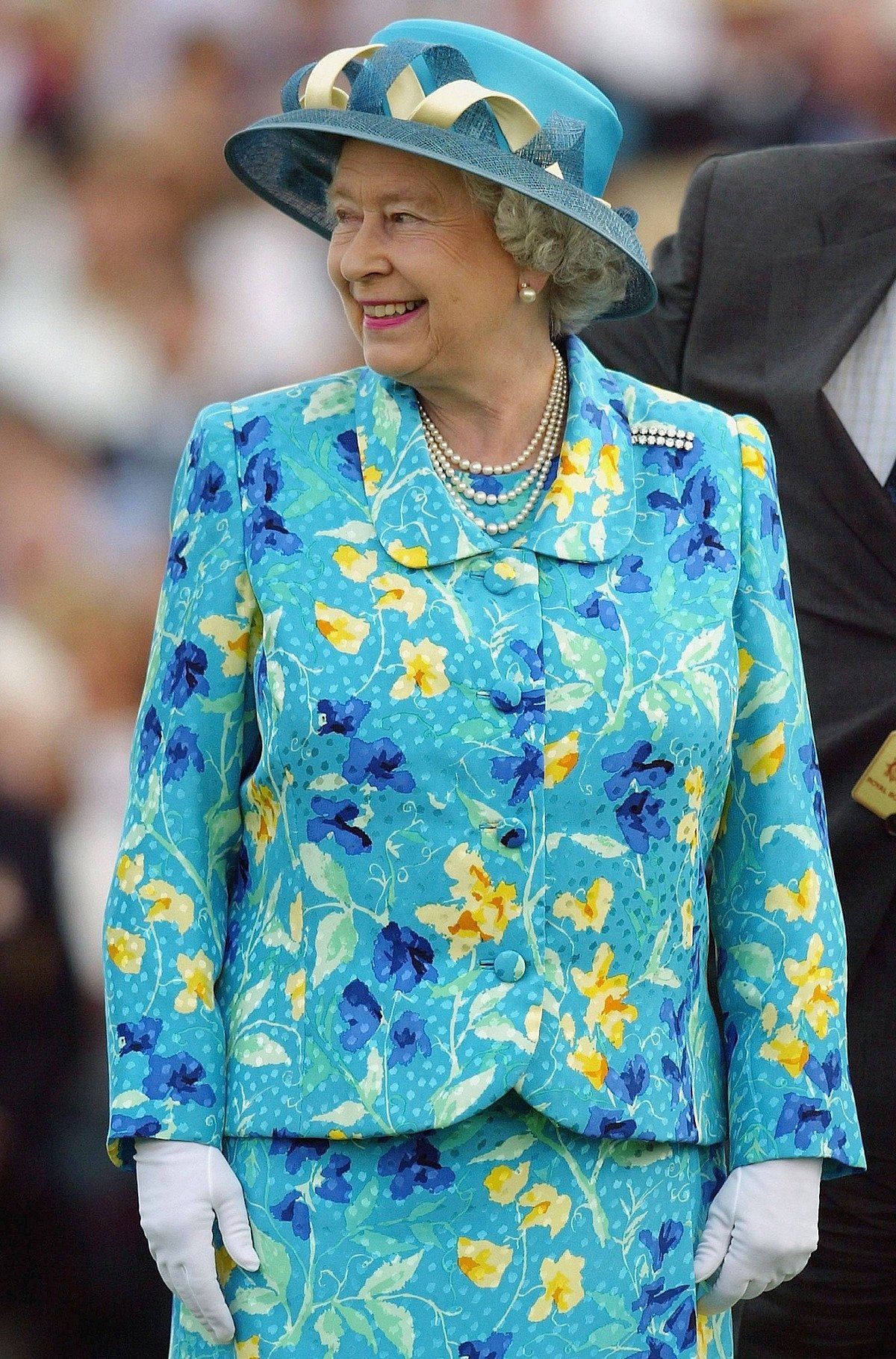 2003: For the Cartier International Polo in Windsor, the Queen chose a vibrant floral skirt suit. She accessorised it with pearl jewellery and a diamond brooch.