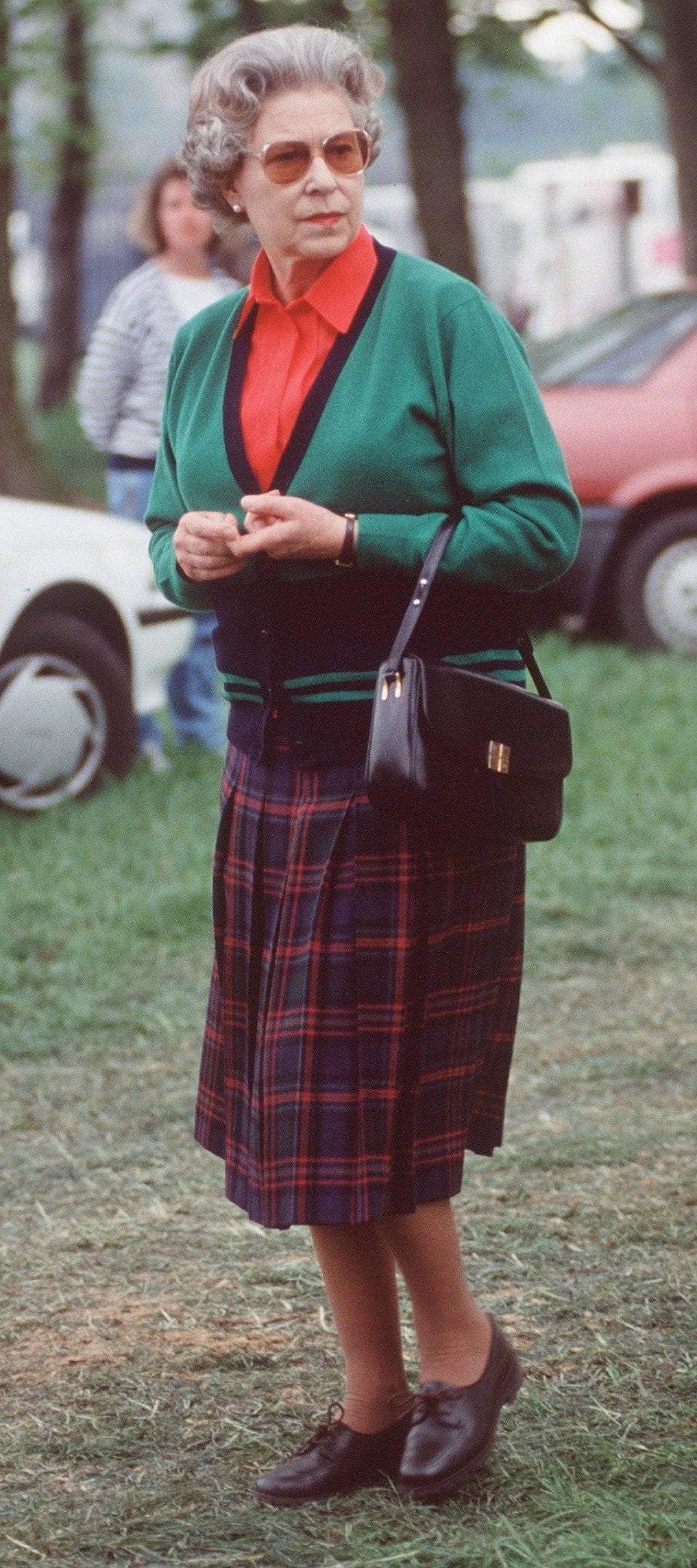 1991: Red shirt, a tartan skirt, paired with a green cardigan and brown brogues during the Royal Windsor Horse Show. Don’t miss the oversized sunglasses.