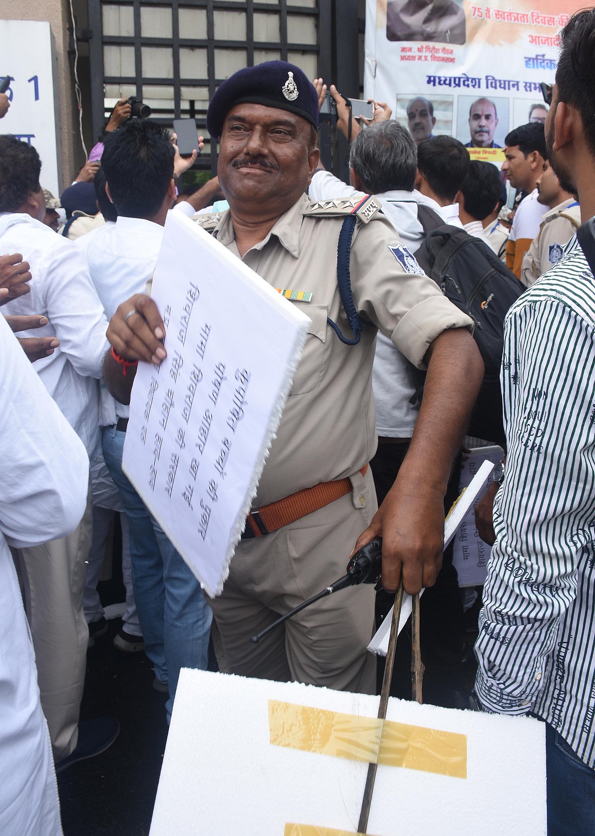 Cops taking away the placards the Congress MLA were carrying