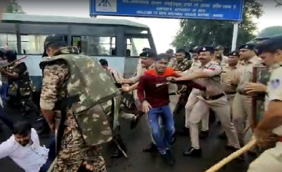 Police chase away protestors outside airport premises on Friday. | 