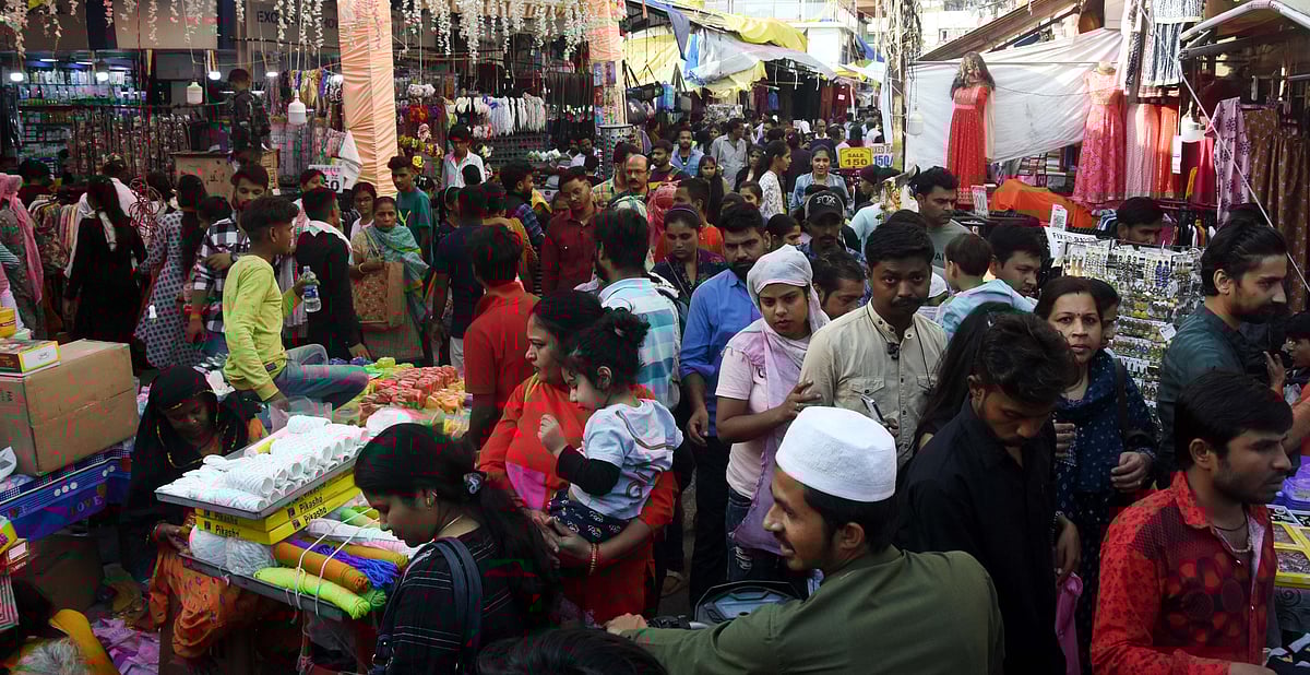 People crowd at a market on the eve of Diwali, in Bhopal on Sunday