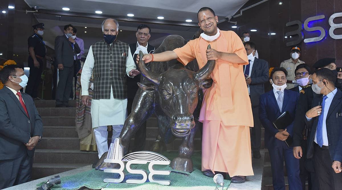 UP CM Yogi Adityanath poses with the bull statue at the BSE during the listing ceremony of Lucknow Nagar Nigam bonds at the exchange, in Mumbai, on December 2, 2020 | PTI