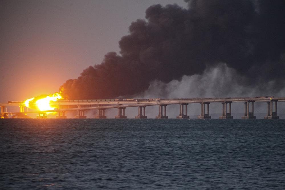 Flame and smoke rise from the Crimean Bridge connecting Russian mainland and the Crimean peninsula over the Kerch Strait, in Kerch, Crimea, on October 8
