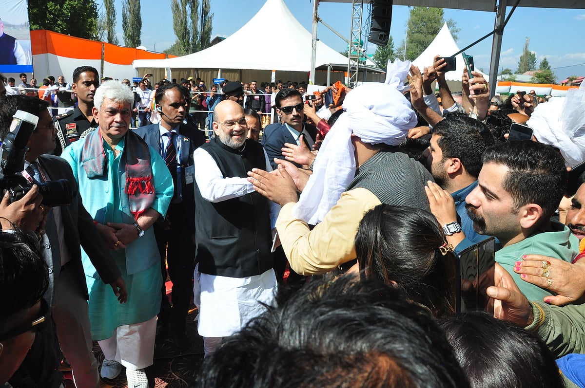 Amit Shah shakes hand with crowd gathered to welcome him  at Showkat Ali Stadium in Baramulla District of Kashmir.