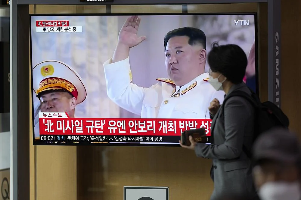 A TV screen showing a news program reporting about North Korea's missile launch with file footage of North Korean leader Kim Jong Un, is seen at the Seoul Railway Station in Seoul, South Korea, on Thursday, October 6 | AP