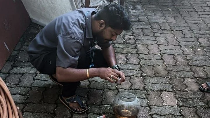 BMC worker administring drops to get rid of dengue larvae.