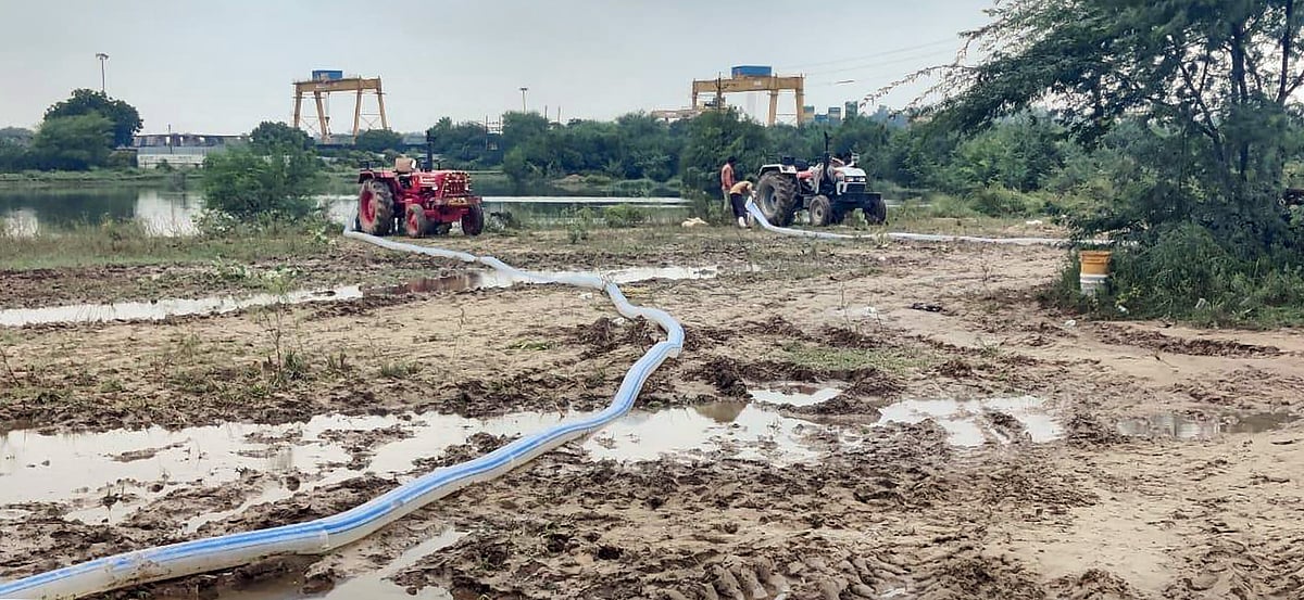 Gurugram workers extract water from the pond after six children died | PTI