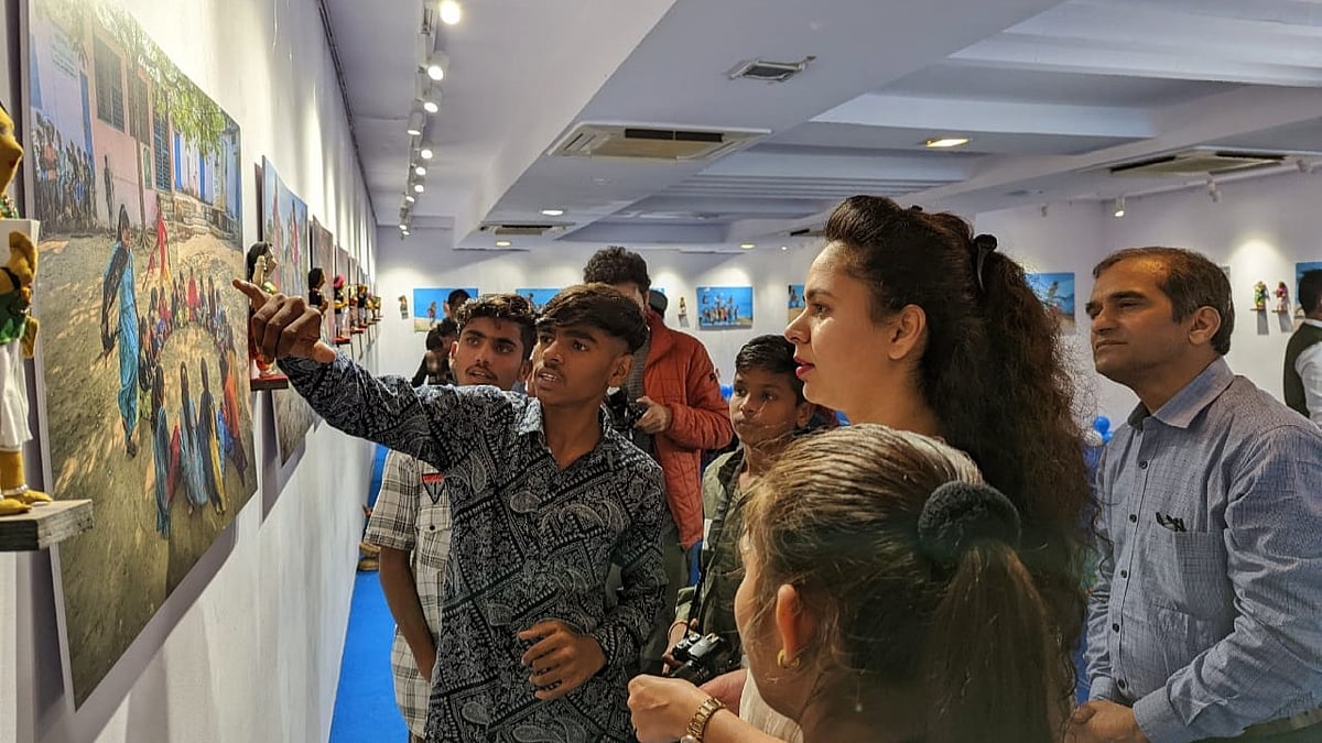 A child photographer explaining his work to the visitors.