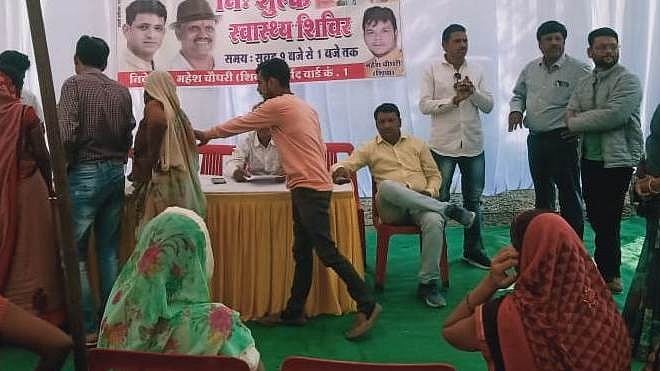 People line up for getting their eyes examined at a free health camp near Khedapati Hanuman Mandir in Ward No. 1 on Monday | FP Photo