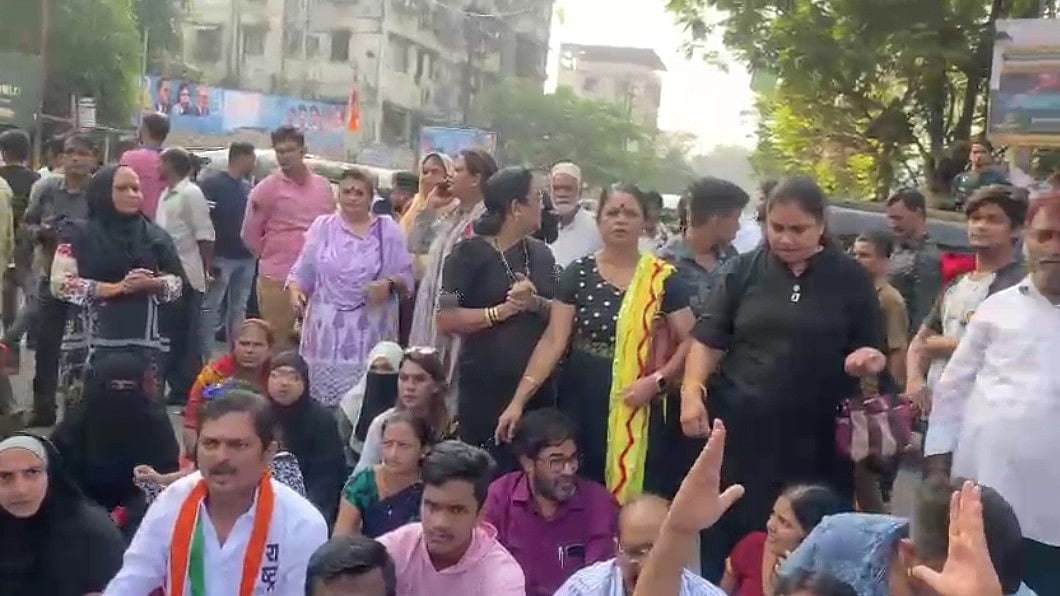 NCP party workers protest outside Mumbra police station against 
molestation charges on Jitendra Awhad