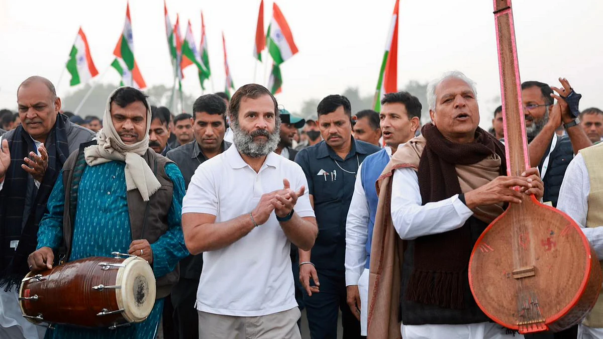 Congress leader Rahul Gandhi with folk singer Prahlad Singh Tipaniya and other supporters during the partys Bharat Jodo Yatra, in Lala Khedi village, Madhya Pradesh, Sunday, Dec. 4, 2022. | PTI