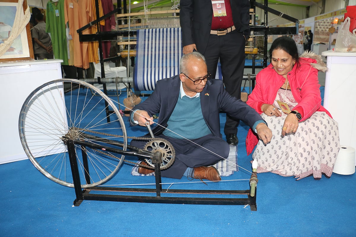 Suriname's foreign minister Albert Ramdin tries his hands at Charkha in Lok Utsav at Lalbagh
