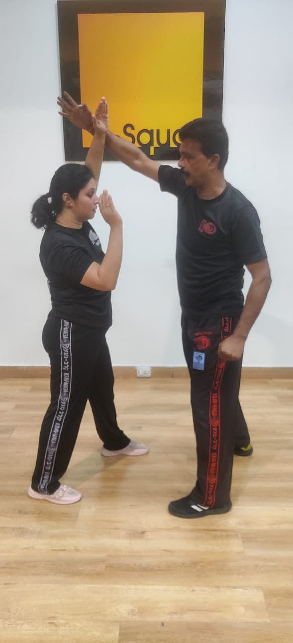 Block the attack using your forearm and simultaneously attack the attacker with either a punch or heel of your palm on his face