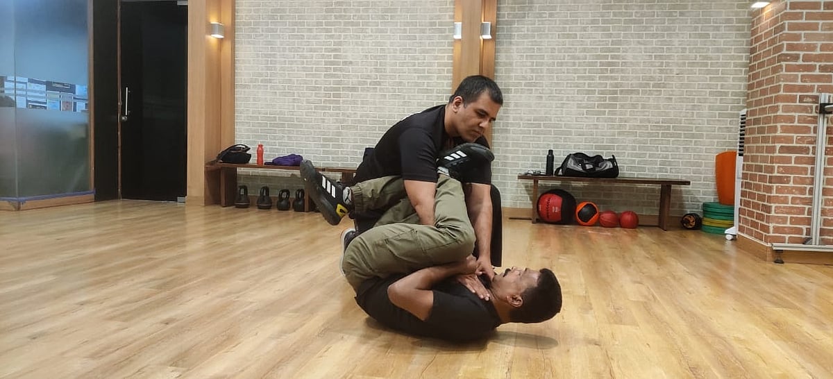 Keep the knees on his chest and with the other leg aim for his face