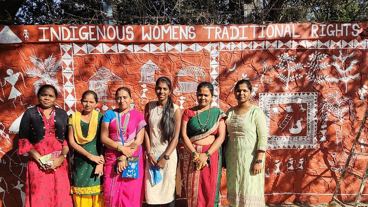 Picture of the artists from Warli Mahila The Dhavaleri Group with the painted wall.  | Pankaj S Raut