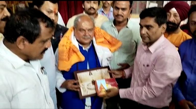 Union minister Narendra Singh Tomar being presented a portrait and prasad on his visit to the Mahakaleshwar Temple in Ujjain on Sunday