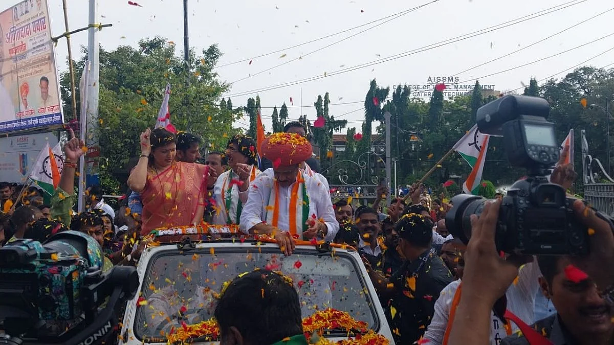 Traditional dhol tasha beats filled the air as flowers rained down upon Ajit Pawar.
