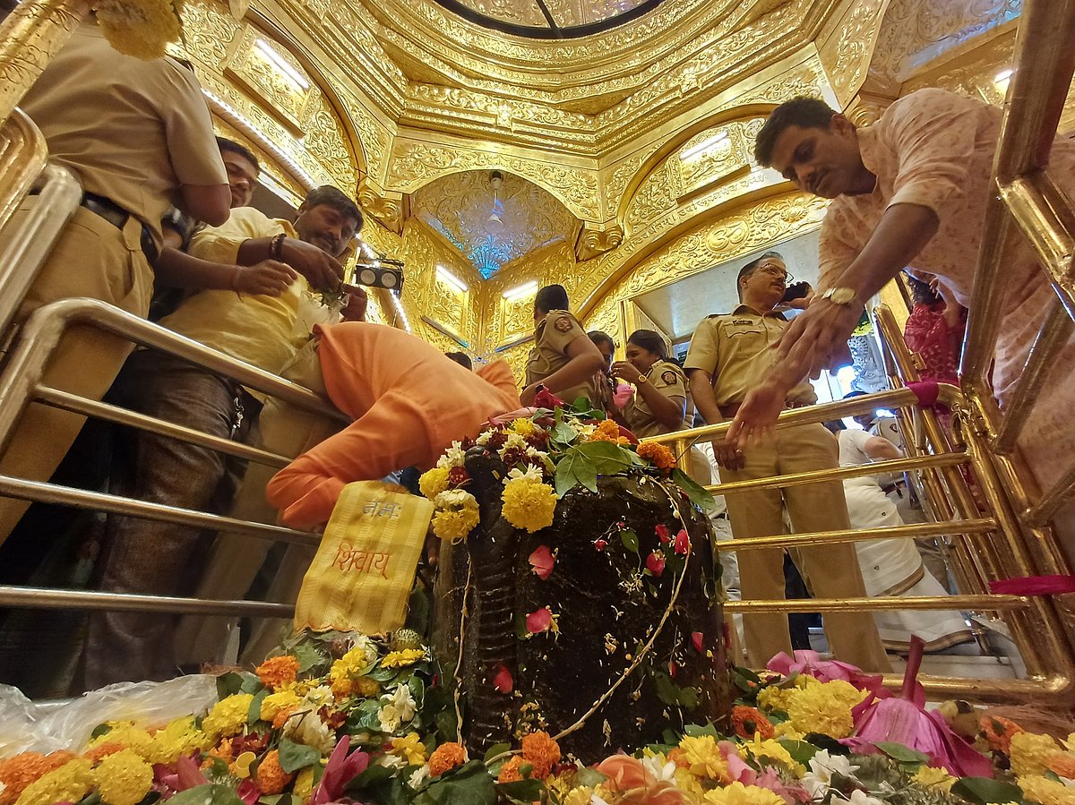Devotees offer prayers to the Shiva linga at Babulnath Temple