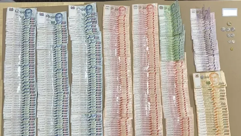 Central Narcotics Bureau officers seized cash during an operation conducted on November 20, 2023. Photo courtesy: CNB