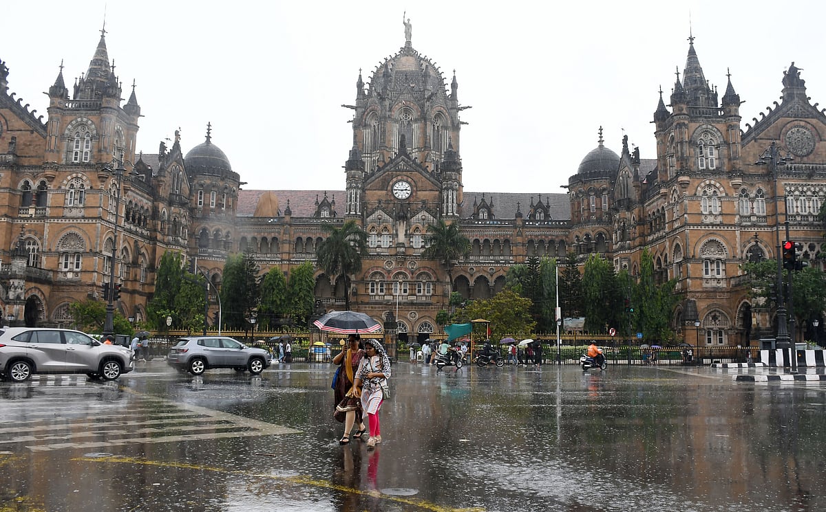 Commuters during rain near the Chhatrapati Shivaji Maharaj Terminus,
in Mumbai