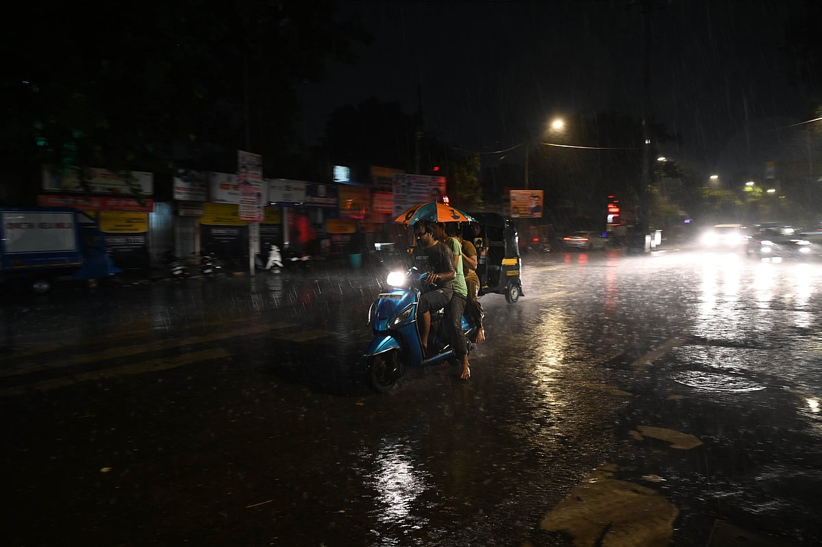 A man rides a motorcycle amid heavy rainfall in Andheri 